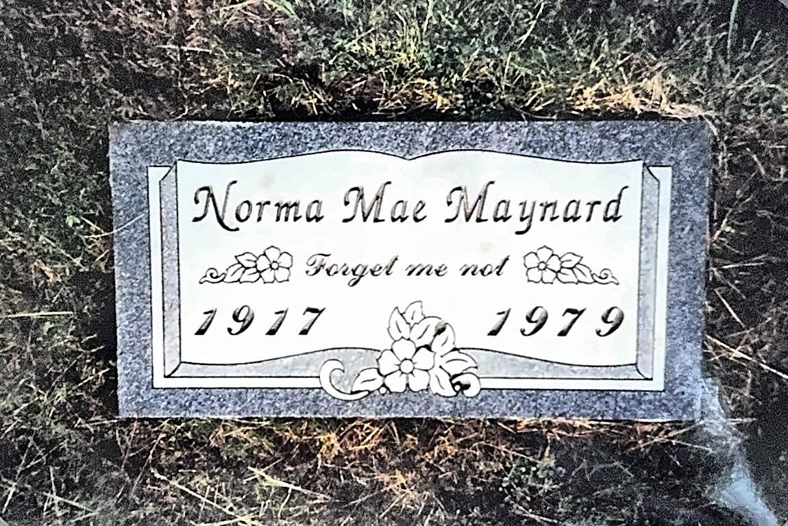 Norma Mae Maynard’s gravestone, engraved Forget me not, 1917–1979, set in grass